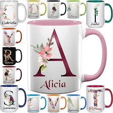 Ceramic coffee mug with various font styles for custom name printing.